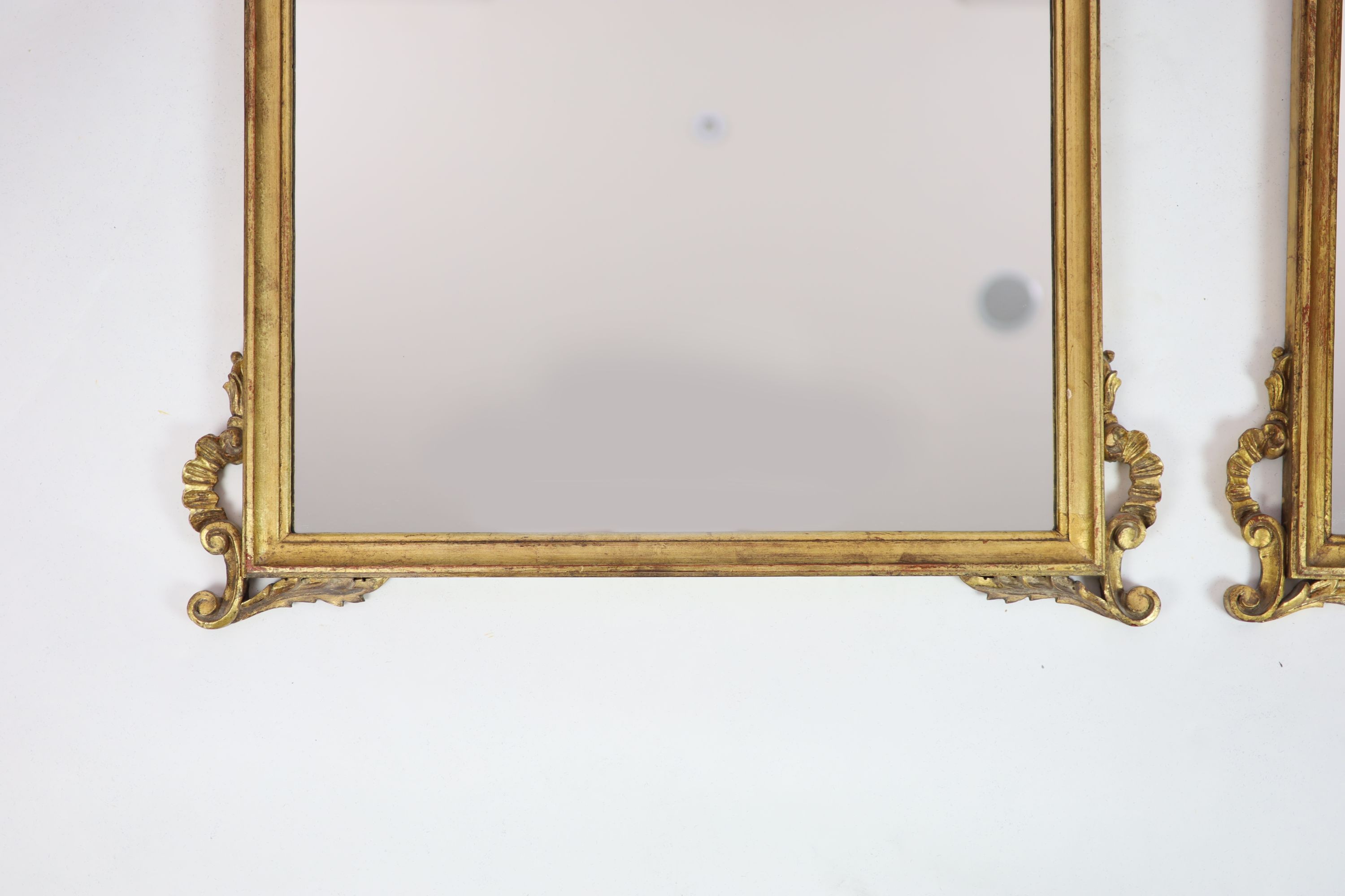 A pair of Georgian style carved giltwood wall mirrors